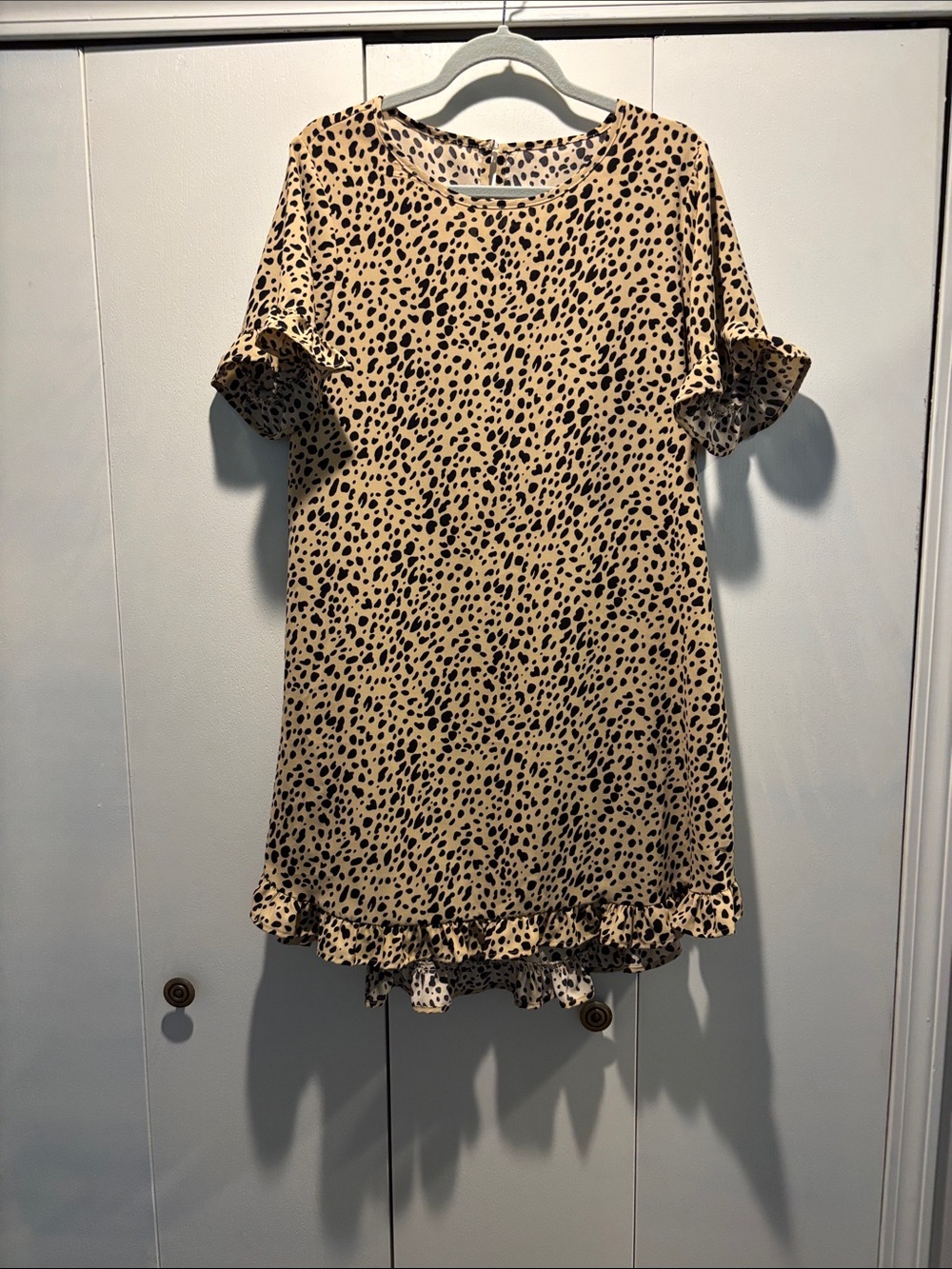 Leopard Print  in Beige and Black ruffle detail on arm and hem.